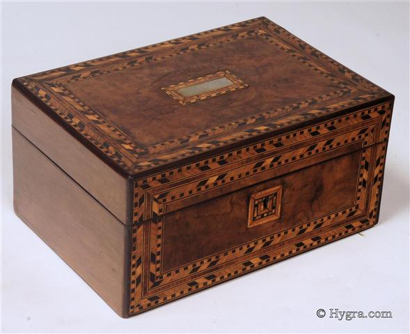 Ref: 639SB:  Figured walnut box with parquetry inlay to the top and front having a n original lift-out tray with supplementary lids covered in purple satin and working lock with key. Circa 1870.   Enlarge Picture